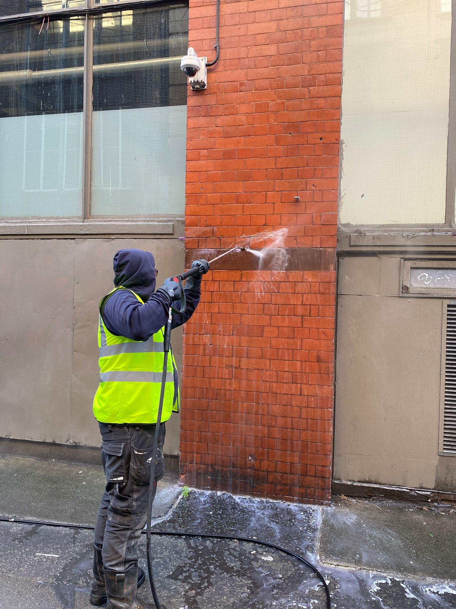 Professional graffiti removal from brick wall